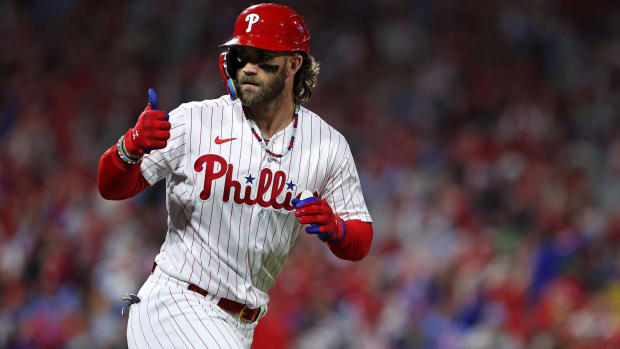 Phillies star hitter Bryce Harper gives a thumbs up to the dugout after hitting a home run.